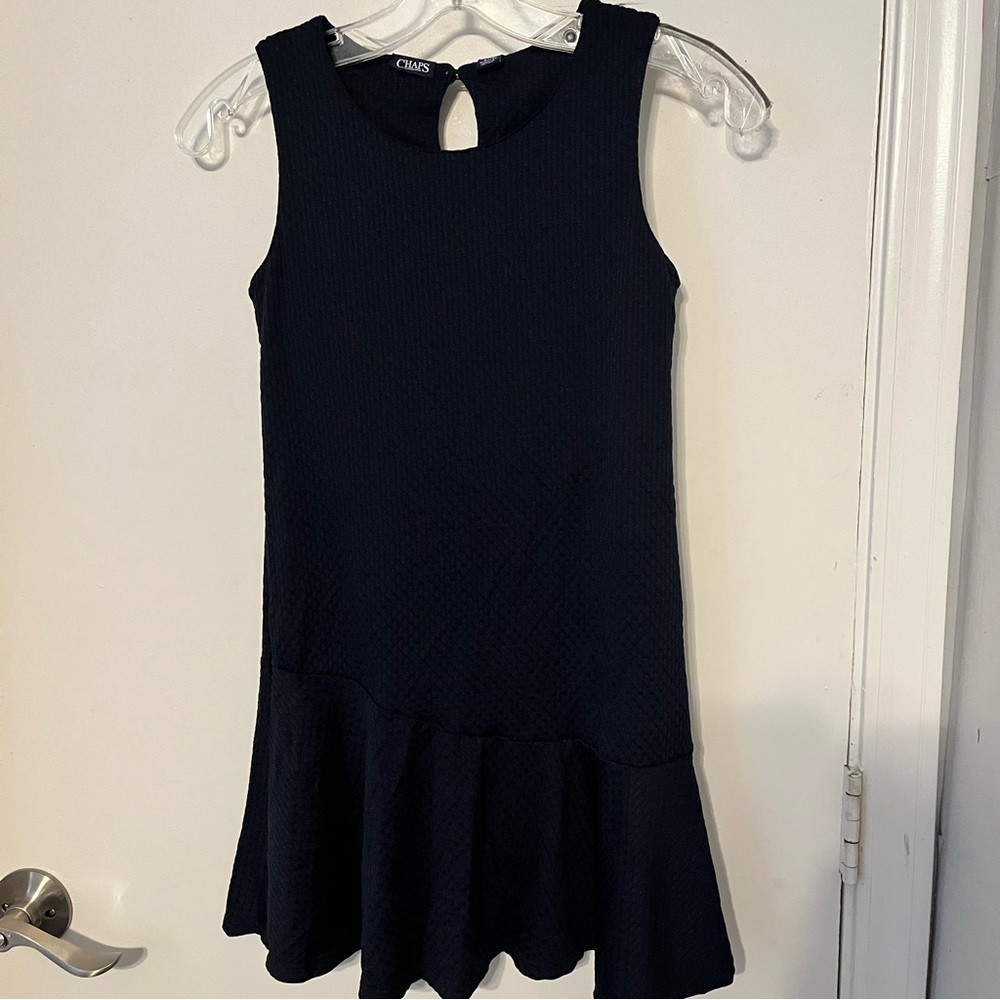 Chaps girls, navy blue jumper flounce hemline and a keyhole closure Size medium.